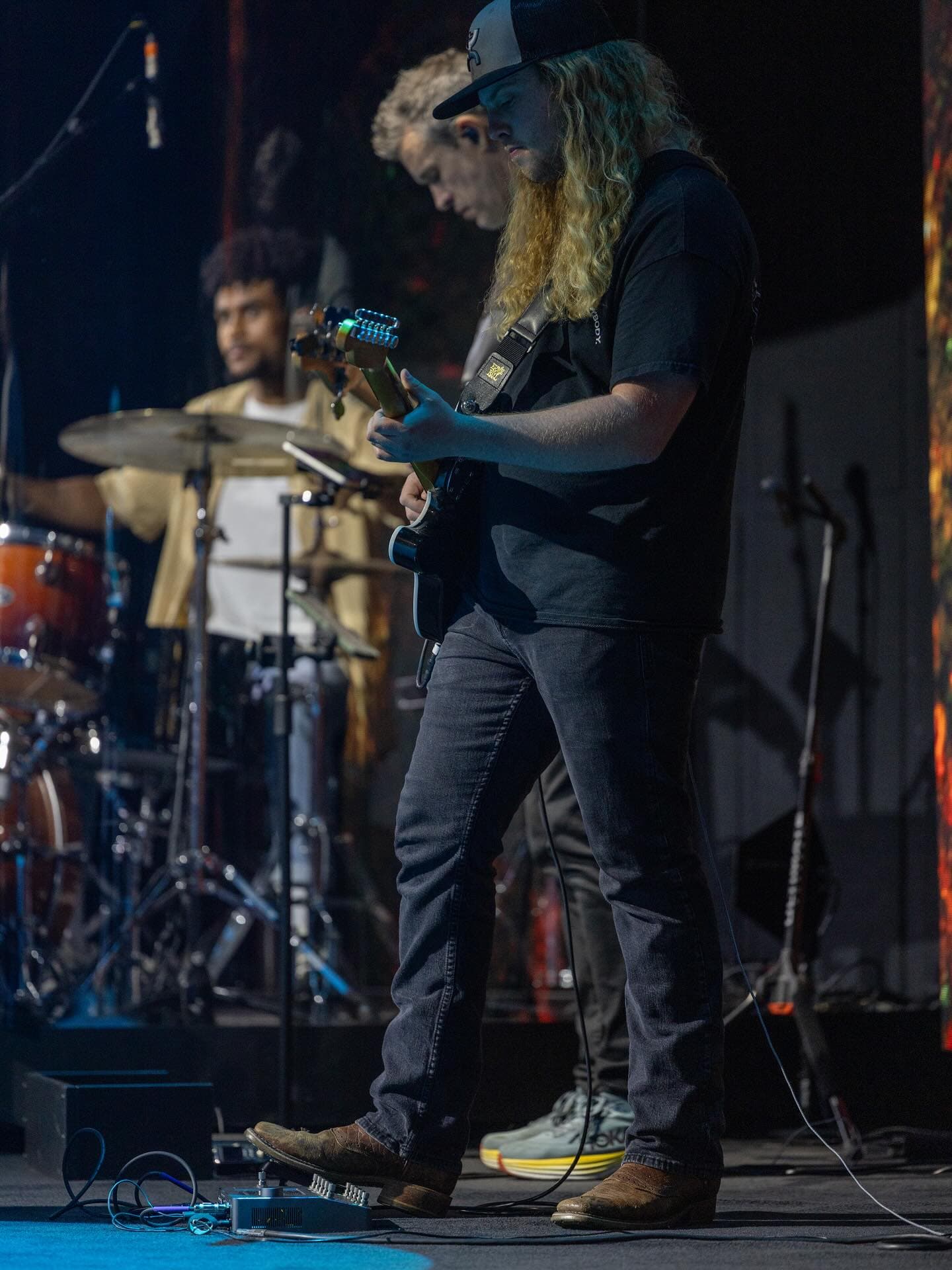 Gunnar Barnett playing guitar with a band onstage
