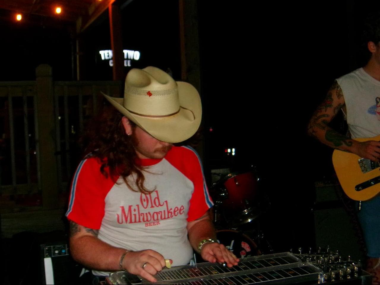 Sam Shoemaker playing pedal steel guitar in a cowboy hat